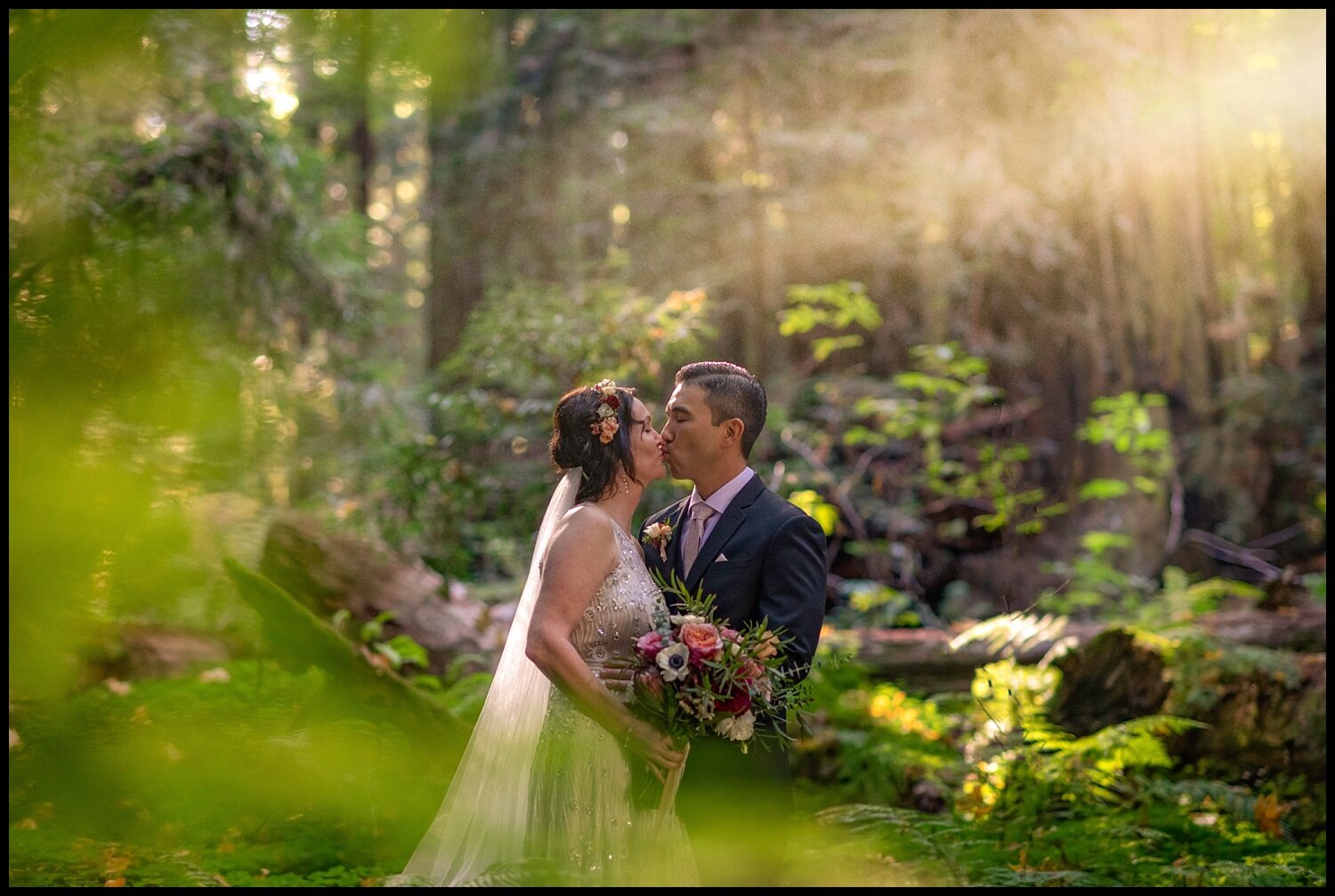 A wedding couple kissing during an elopement in the redwoods.